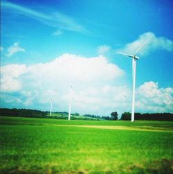 Wind turbines on grassy field