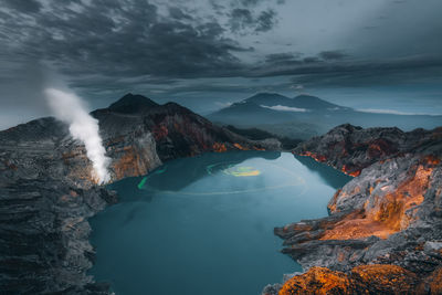 Scenic view of ijen crater and mountains against sky