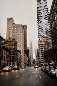 City street amidst buildings against sky