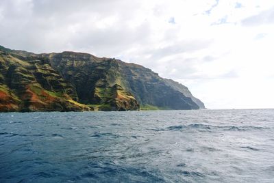 Scenic view of sea and mountains against sky