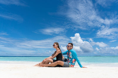 Young couple sitting on beach