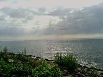 Scenic view of sea against cloudy sky