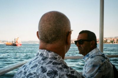 Portrait of people in sea against clear sky