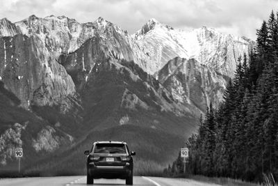 Cars on mountain against sky