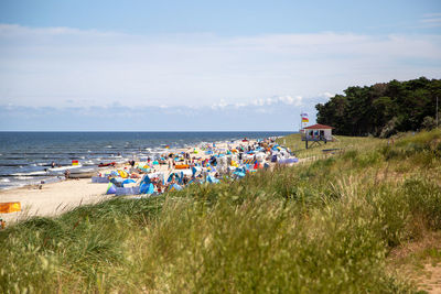 People on beach against sky