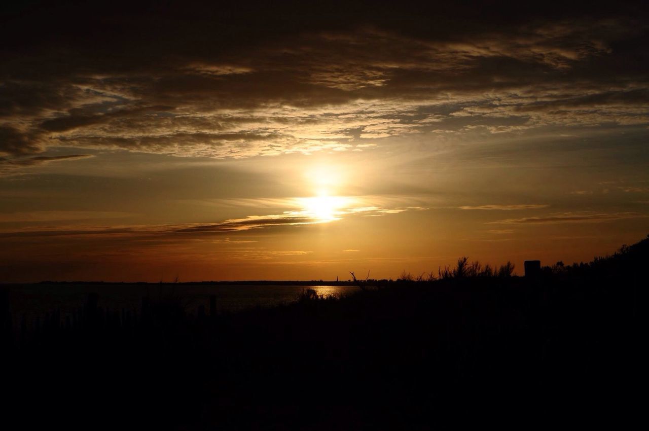 sunset, tranquil scene, scenics, silhouette, tranquility, beauty in nature, sky, sun, landscape, idyllic, orange color, nature, cloud - sky, cloud, horizon over land, sunlight, field, outdoors, non-urban scene, remote