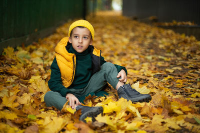 Portrait of young woman sitting on field