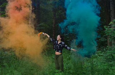 Full length of woman standing in forest