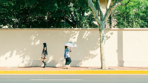 Full length of woman walking on street