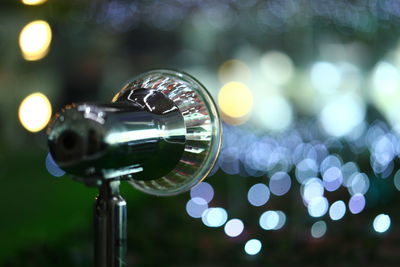 Close-up of illuminated lighting equipment at night