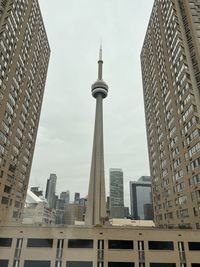 Buildings in city - cn tower framed by residential buildings