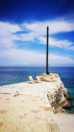 Lifeguard hut on beach against sky