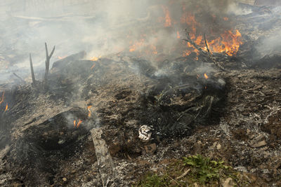 Burning of garbage. set fire to illegal landfill. flames and smoke. environmental disaster.