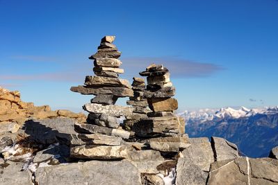 Stack of rocks on mountain against sky