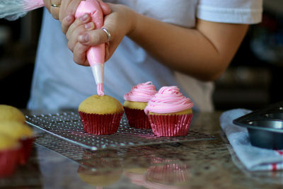 Midsection of woman holding ice cream