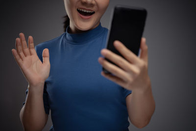 Midsection of woman using mobile phone