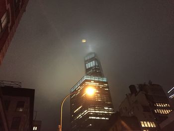 Low angle view of buildings against sky at night