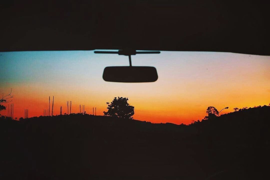 SILHOUETTE CAR AGAINST ORANGE SKY