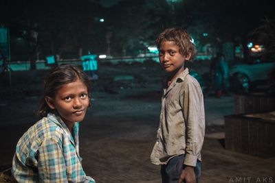 Portrait of happy boy outdoors at night