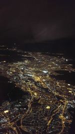 Aerial view of illuminated city at night