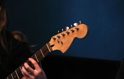 Cropped hand of woman playing guitar