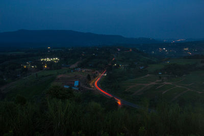 High angle view of light trails on road against sky at night