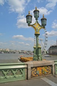 View of street light by sea against sky