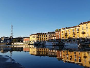 View of buildings against clear blue sky