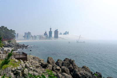 Scenic view of sea and buildings against sky