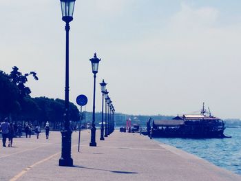 Street by sea against clear sky