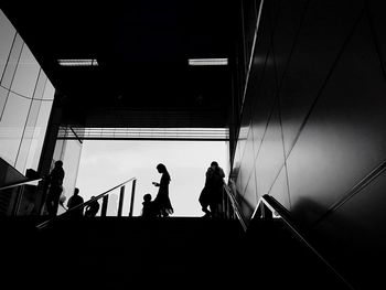 Low angle view of silhouette people on staircase