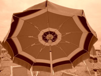 Close-up of umbrella against sky