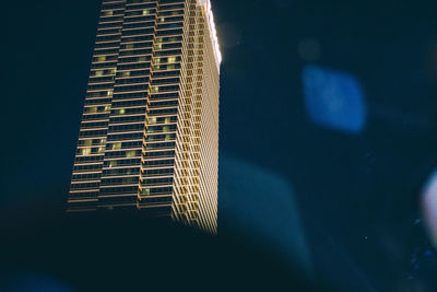 Low angle view of modern building at night