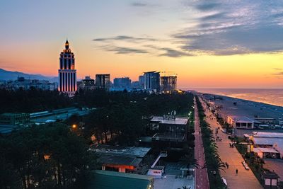 High angle view of buildings in city during sunset