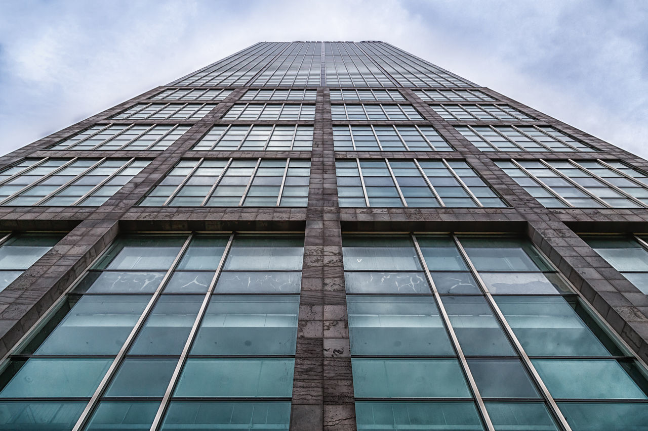 architecture, building exterior, low angle view, built structure, modern, office building, glass - material, reflection, tall - high, sky, city, skyscraper, building, tower, window, cloud - sky, glass, day, cloud, outdoors