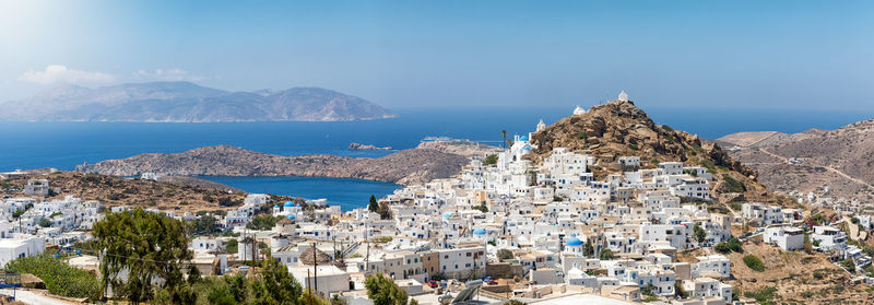 High angle view of townscape by sea against sky