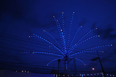 Low angle view of illuminated ferris wheel at night