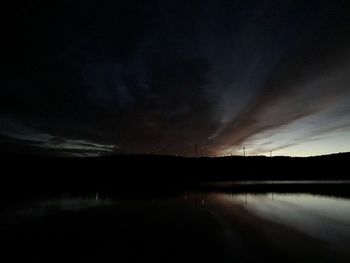 Scenic view of lake against sky at night