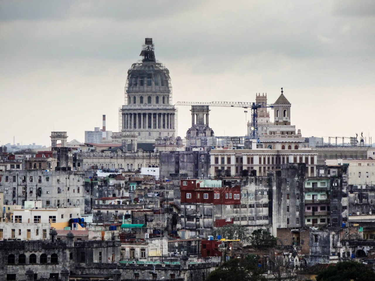 BUILDINGS AGAINST CLOUDY SKY