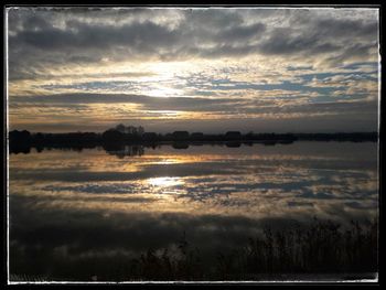 Scenic view of lake against sky during sunset