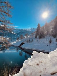 Scenic view of snow covered lake against sky