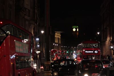 Illuminated city against sky at night