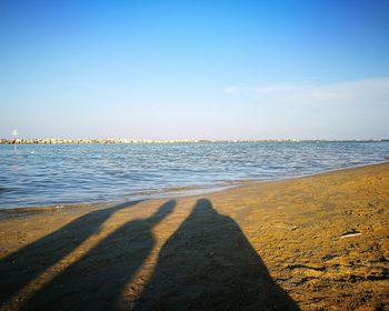 Scenic view of beach against blue sky