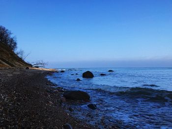 Scenic view of sea against clear blue sky