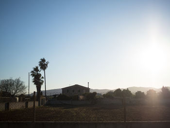 Scenic view of landscape against clear sky during sunset