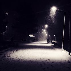 Snow covered road at night