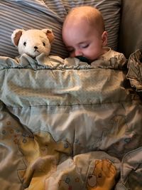 Cute boy sleeping on bed