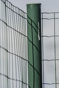 Metal fence against sky