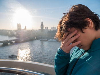 Portrait of man in city against sky