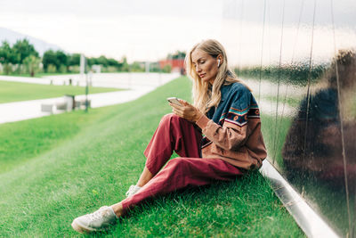 Portrait of young woman sitting on field